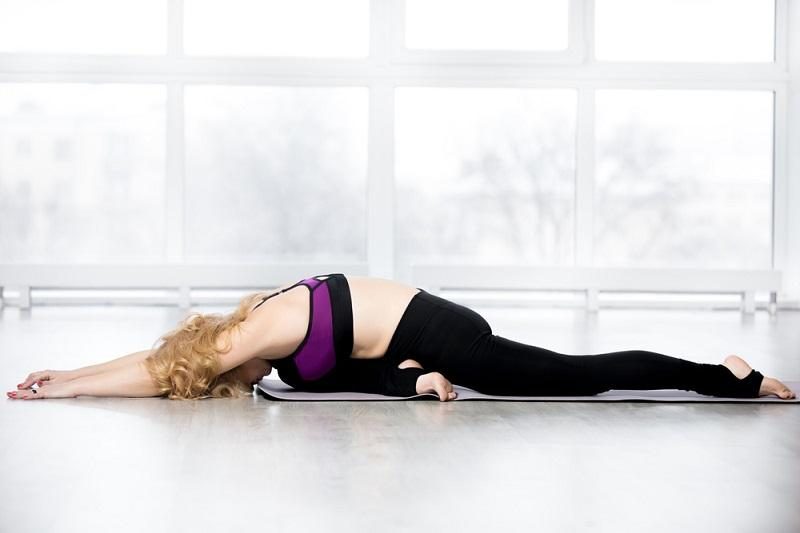 senior-woman-doing-sleeping-swan-yoga-pose